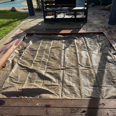 Custom sandpit cover fitted securely over a preschool sandpit